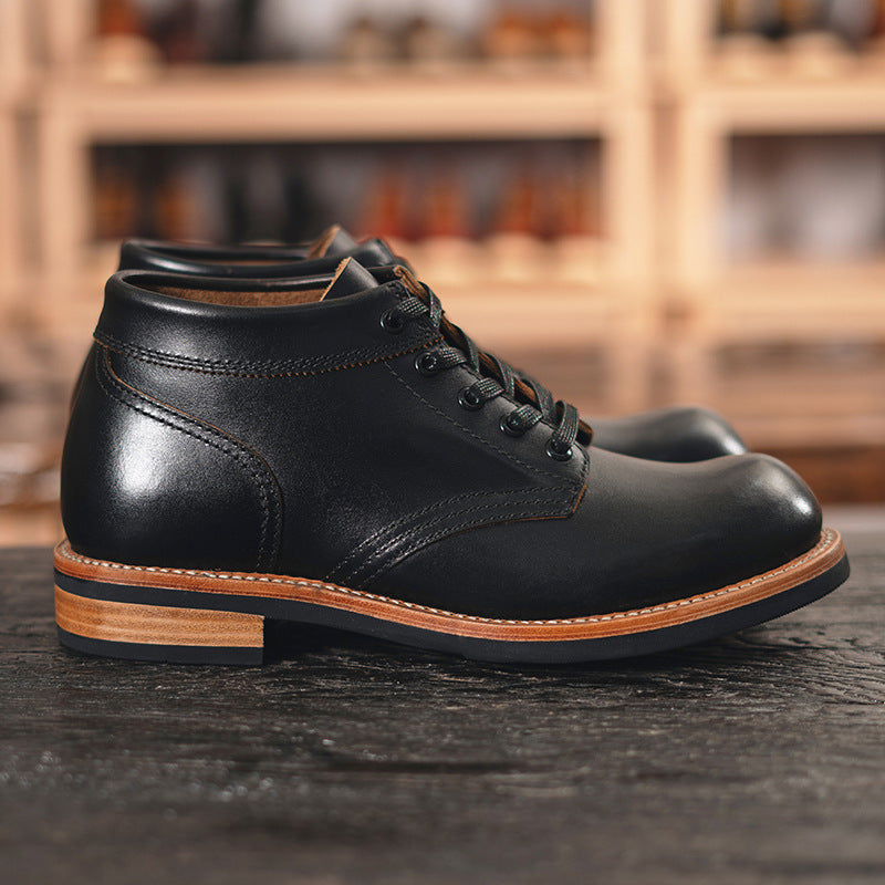 A sleek black leather boot featuring a durable rubber sole, ideal for both style and comfort in various settings.