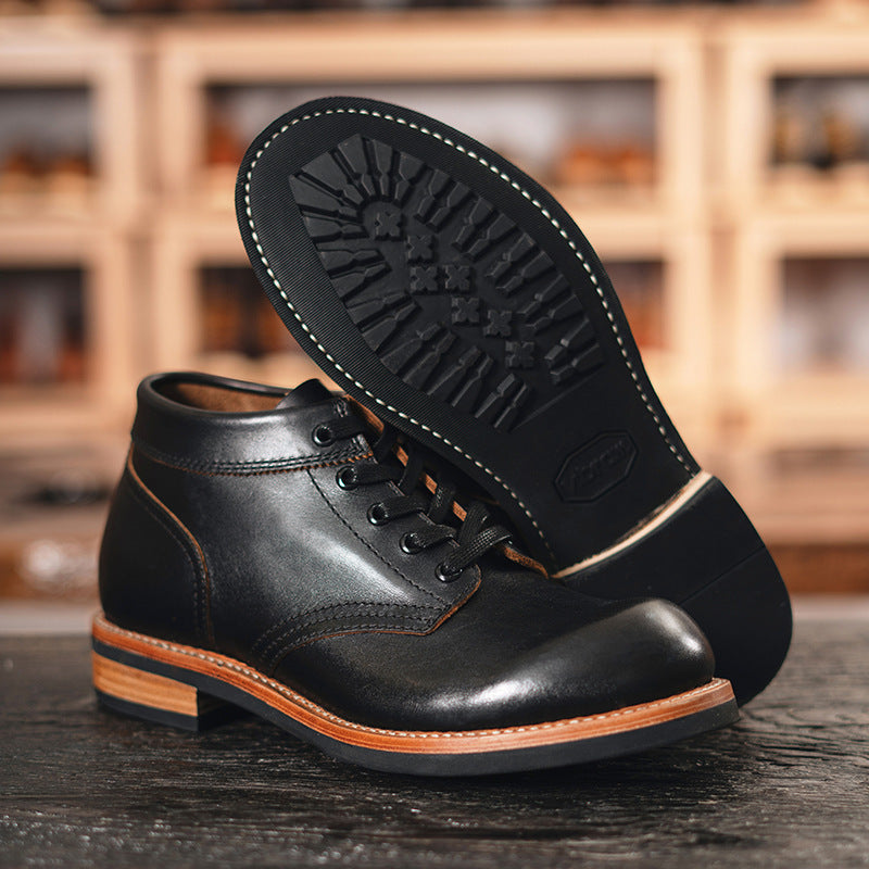 A sleek black leather boot featuring a durable rubber sole, ideal for both style and comfort in various settings.