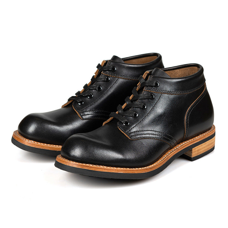 A sleek black leather boot featuring a durable rubber sole, ideal for both style and comfort in various settings.